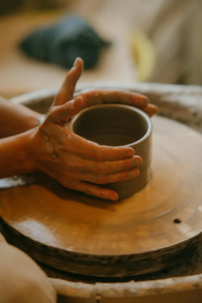 Melanie Tuck creating a cup on a pottery wheel